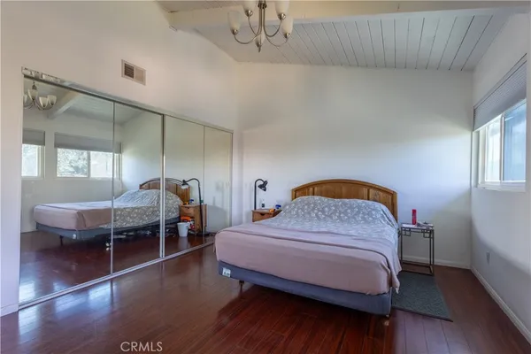 a bedroom with a bed a table and chair