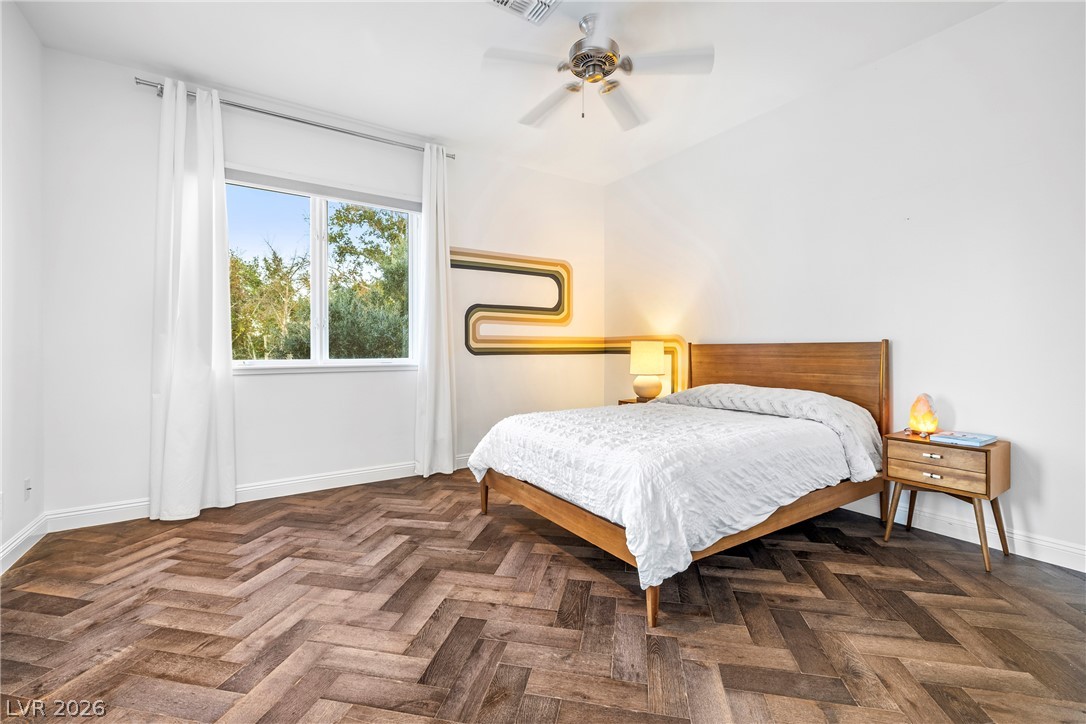 2000 Grouse Street Las Vegas, NV 89134 - Photo 35 of 89 Herringbone hardwood floors and a ceiling fan complete this bedroom retreat.
