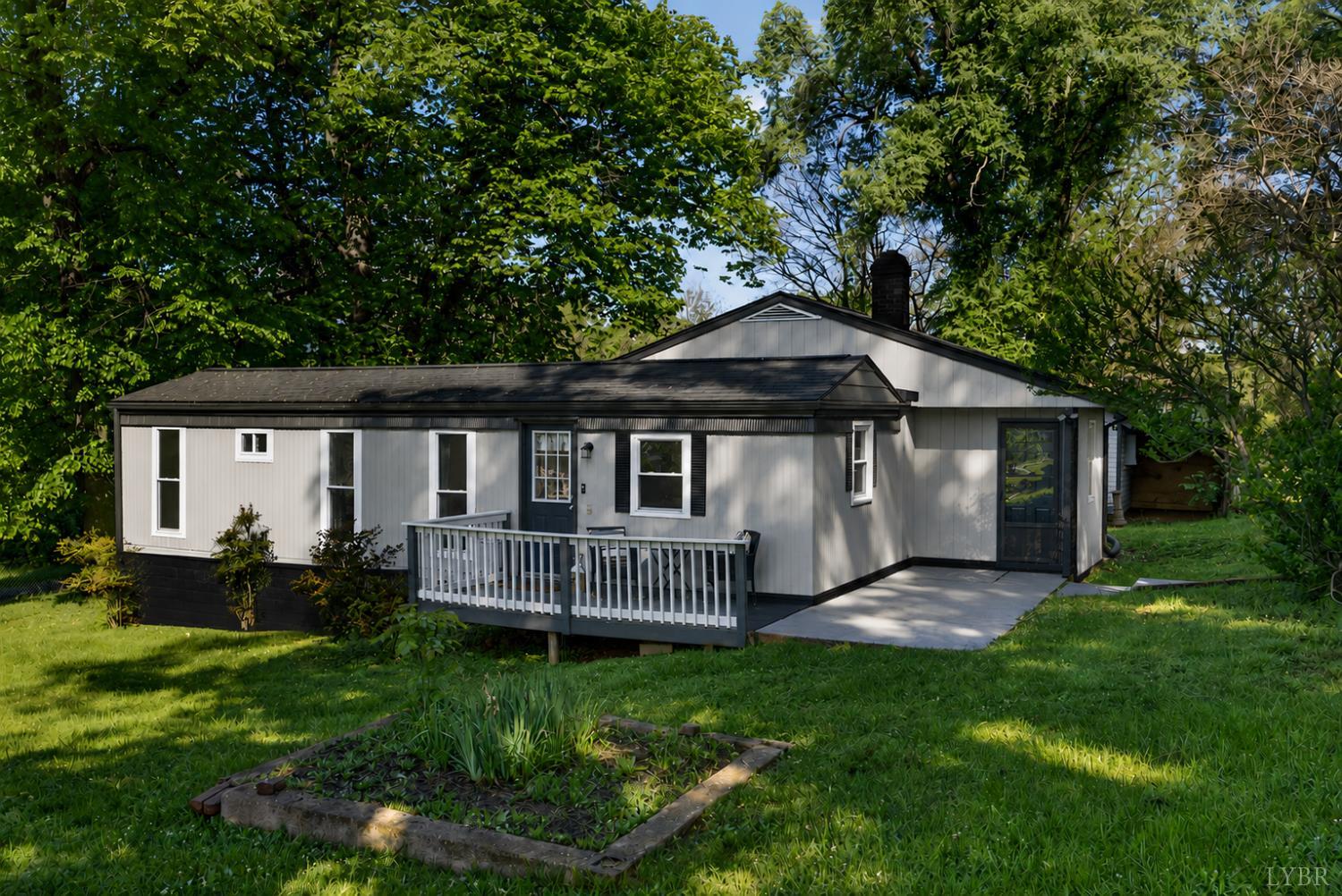 151 Brooks Street Monroe, VA 24574 - Photo 1 of 42 a view of a house with a yard deck and a large tree