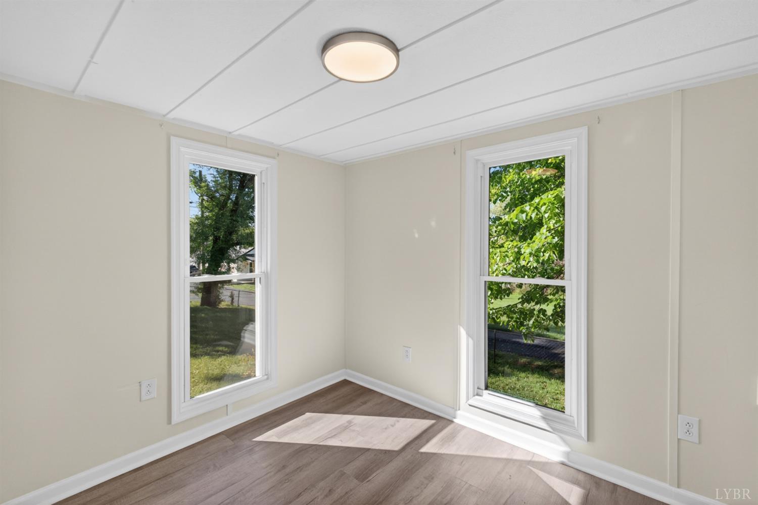 151 Brooks Street Monroe, VA 24574 - Photo 11 of 42 an empty room with wooden floor and windows