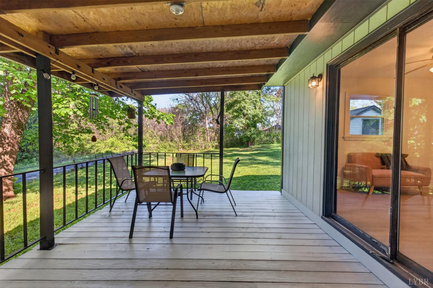 151 Brooks Street Monroe, VA 24574 - Photo 13 of 42 a view of a patio with a table chairs and wooden floor