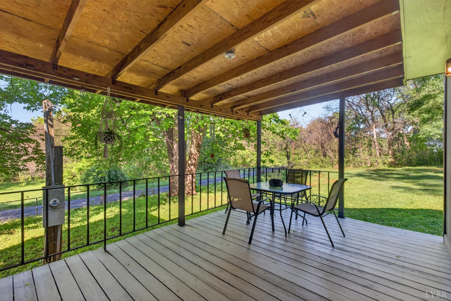 151 Brooks Street Monroe, VA 24574 - Photo 15 of 42 a view of a patio with a table chairs and a patio