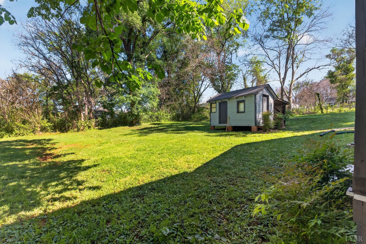 151 Brooks Street Monroe, VA 24574 - Photo 36 of 42 a view of a house with a big yard and large trees