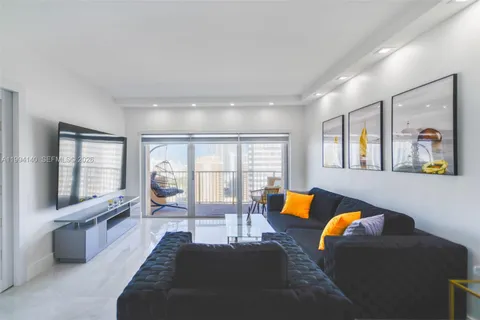 a living room with furniture and large windows