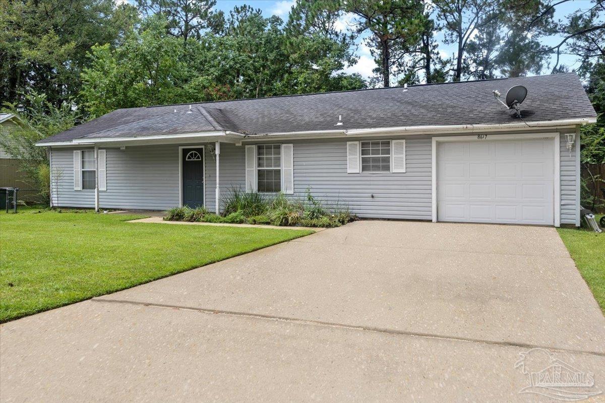 8617 Blue Jay Way Pensacola, FL 32534 - Photo 18 of 28 a view of a yard in front of a house with plants and large tree
