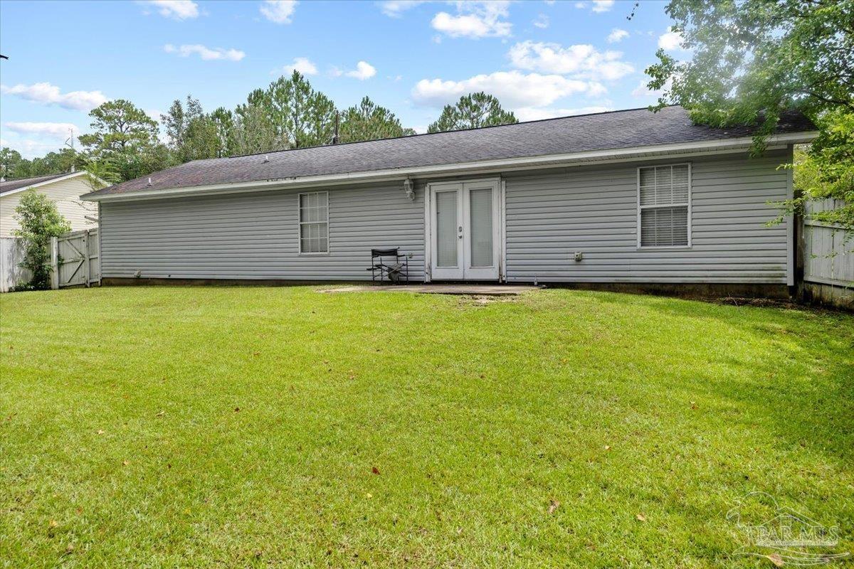 8617 Blue Jay Way Pensacola, FL 32534 - Photo 21 of 28 a view of a backyard with a garden