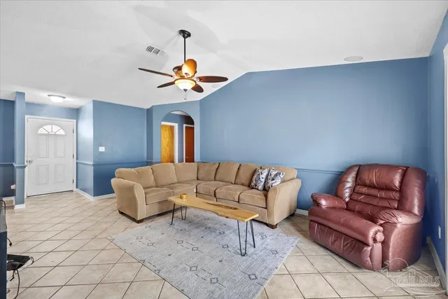 a living room with furniture and a chandelier