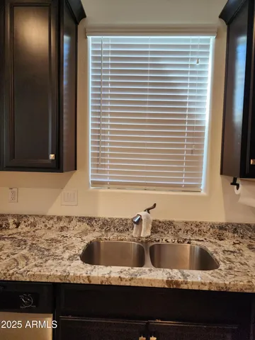 a kitchen with a sink a stove a refrigerator and cabinets