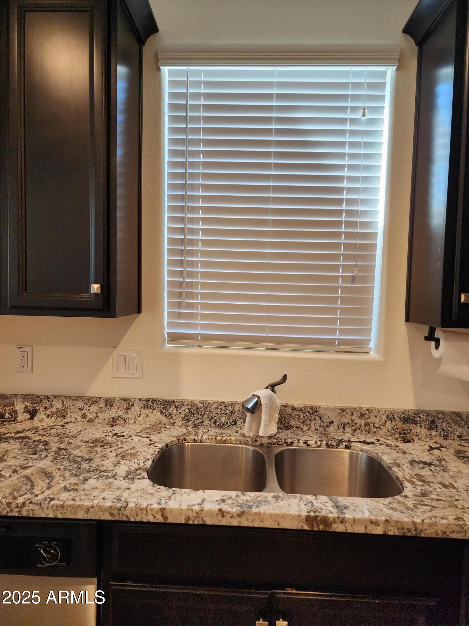 14870 West Encanto Boulevard, Unit 1113 Goodyear, AZ 85395 - Photo 11 of 33 a bathroom with a granite countertop sink and a large mirror
