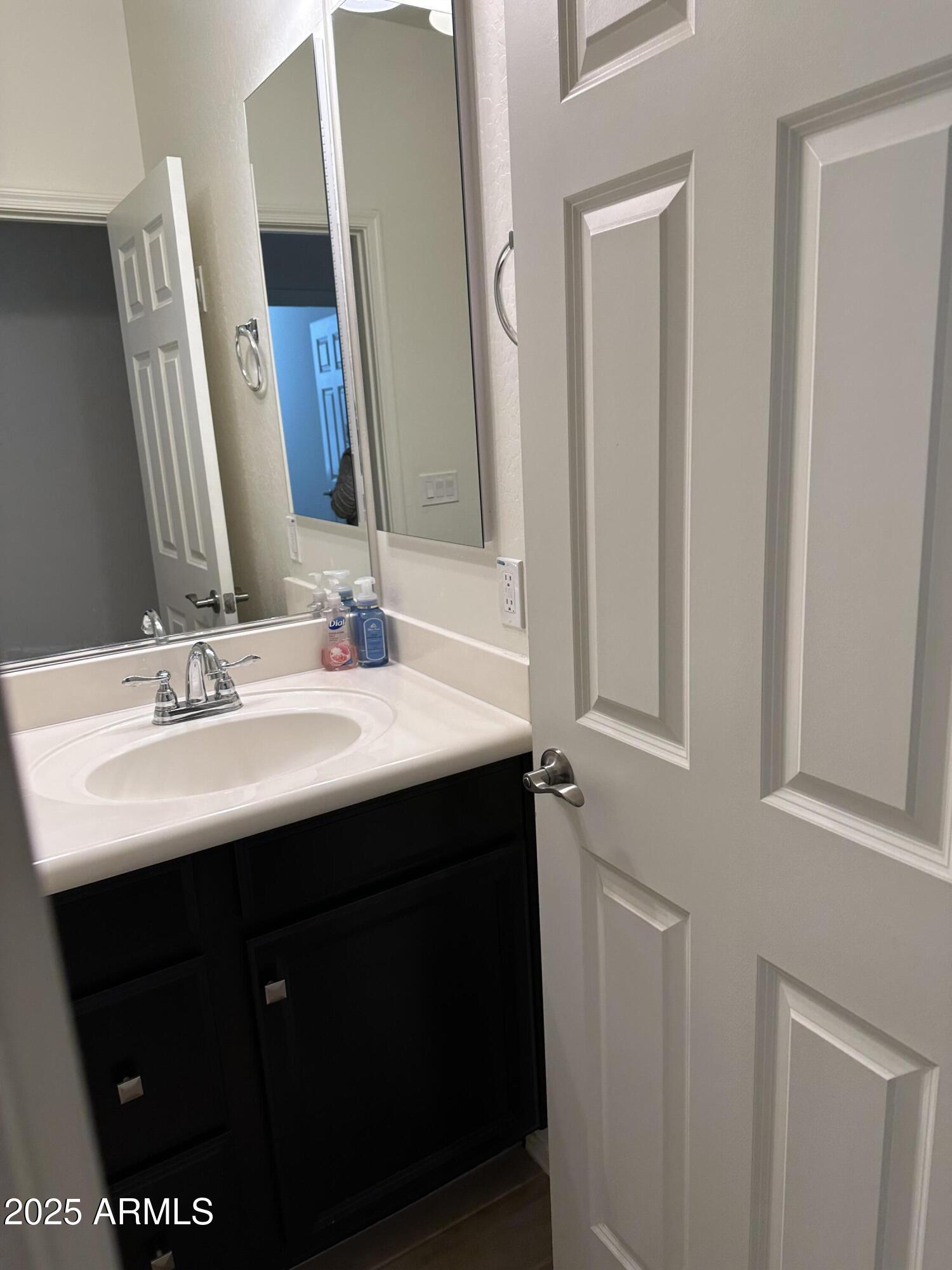14870 West Encanto Boulevard, Unit 1113 Goodyear, AZ 85395 - Photo 18 of 33 a bathroom with a sink and a mirror