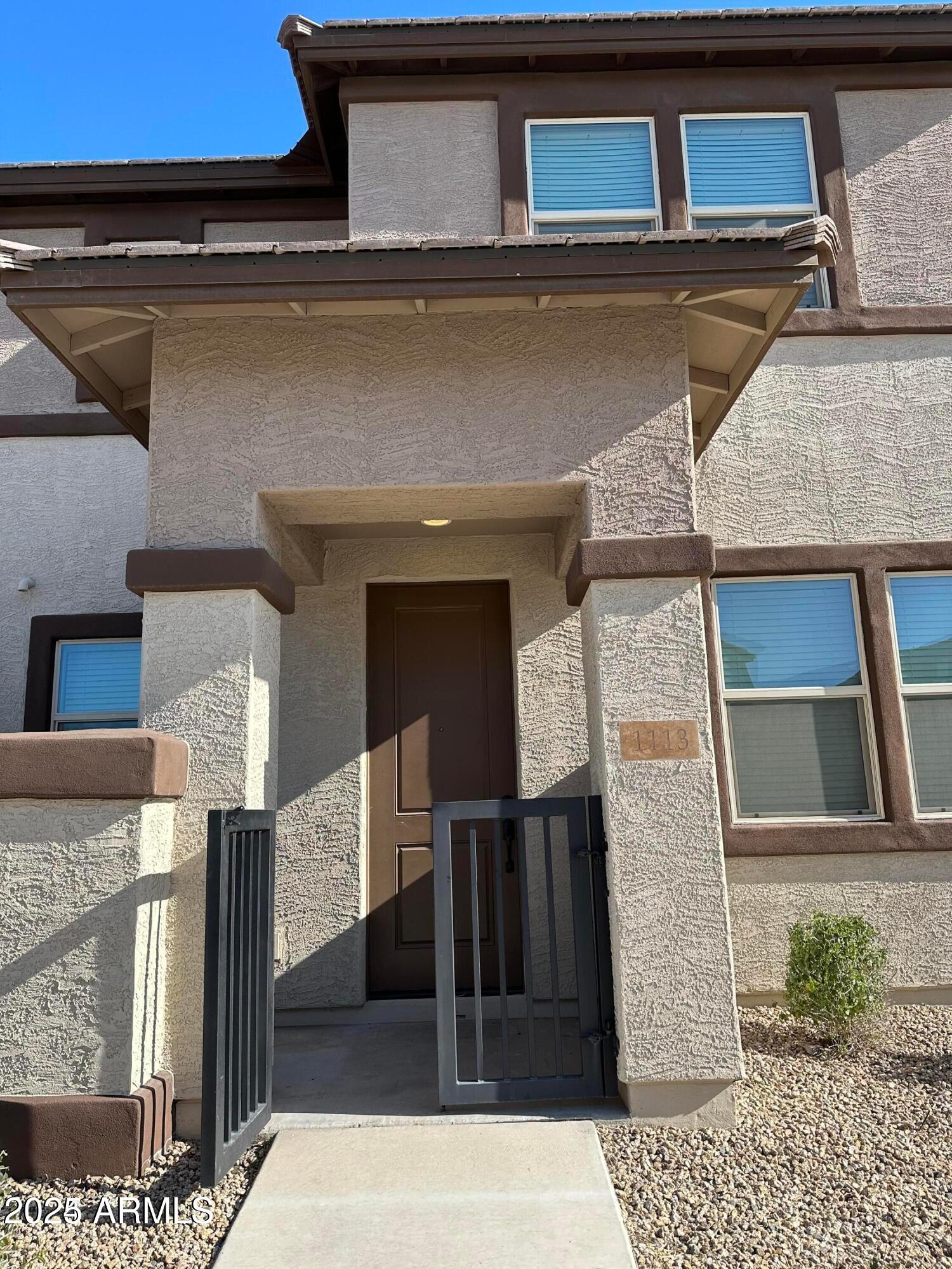 14870 West Encanto Boulevard, Unit 1113 Goodyear, AZ 85395 - Photo 2 of 33 a view of a house with a door