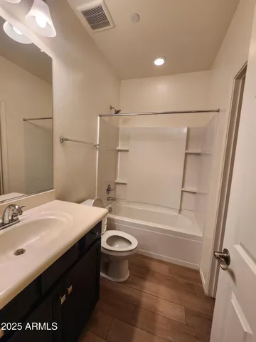 a bathroom with a double vanity sink a toilet and a mirror