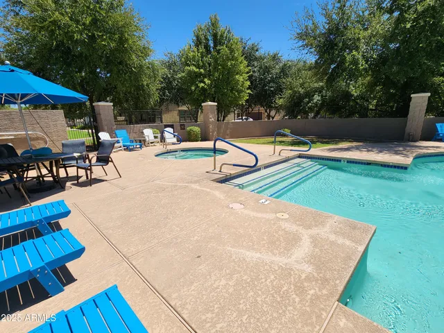 a front view of a house with swimming pool garden and outdoor seating