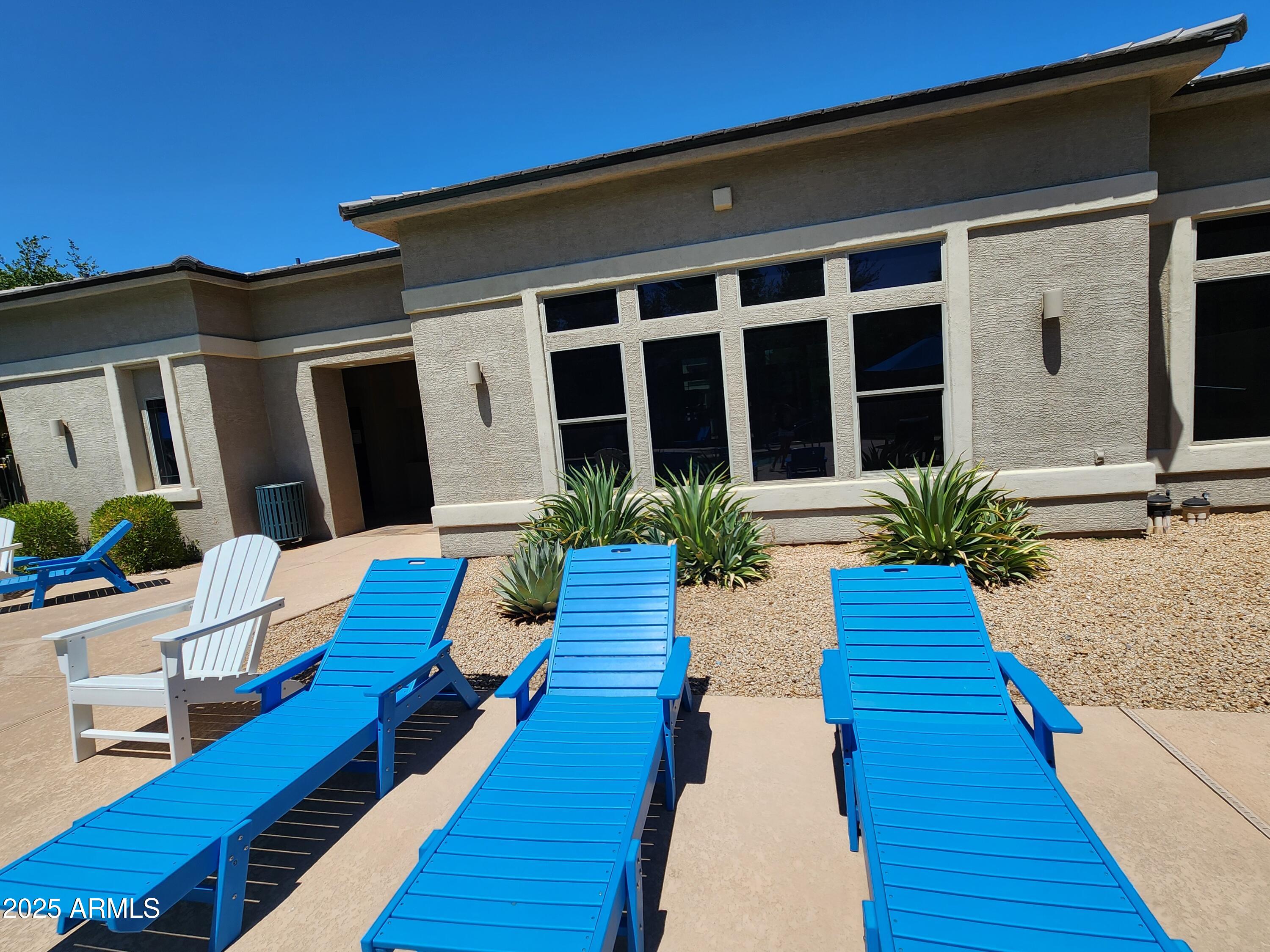 14870 West Encanto Boulevard, Unit 1113 Goodyear, AZ 85395 - Photo 29 of 33 a swimming pool with outdoor seating