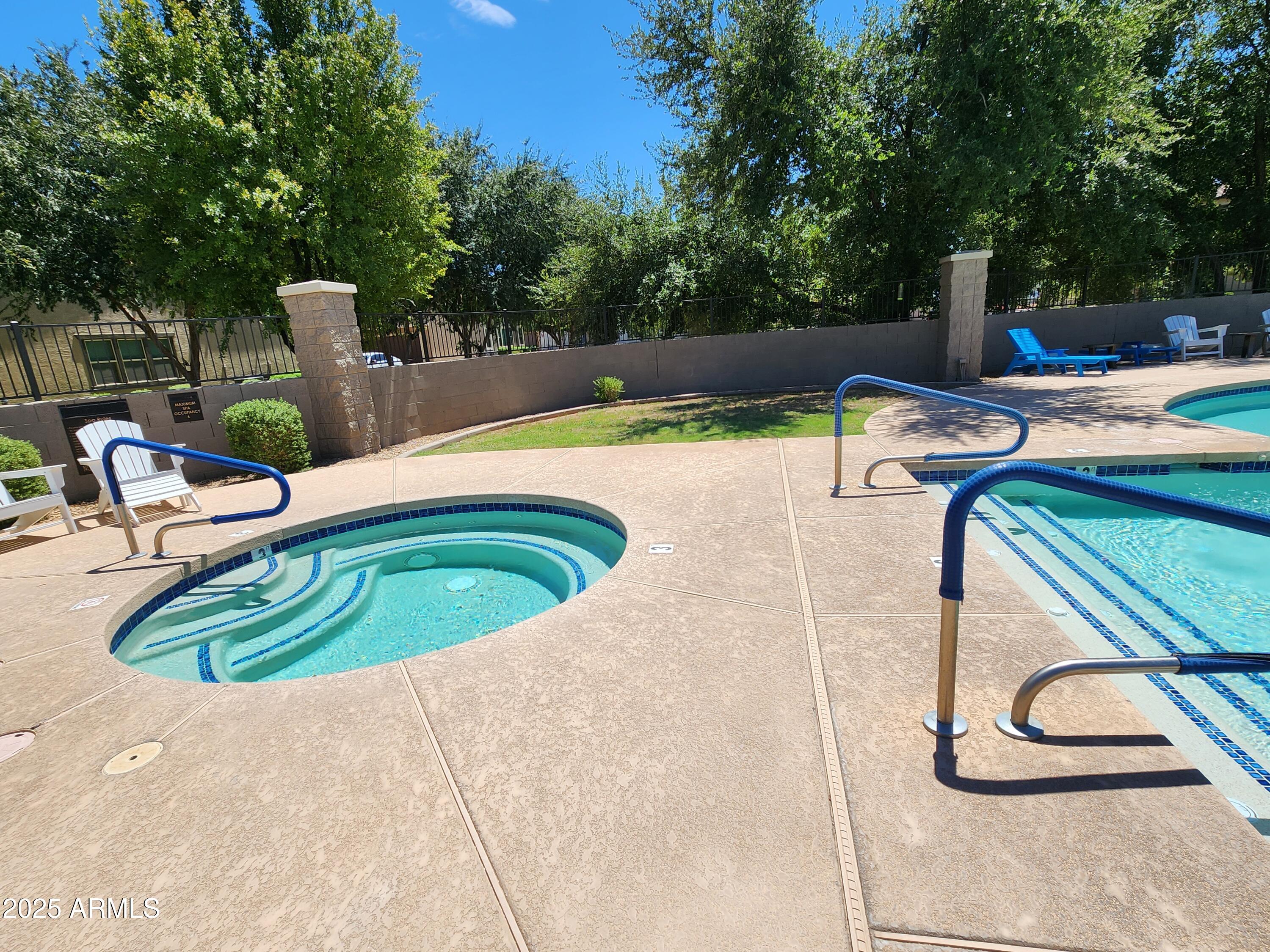 14870 West Encanto Boulevard, Unit 1113 Goodyear, AZ 85395 - Photo 30 of 33 a swimming pool with plants