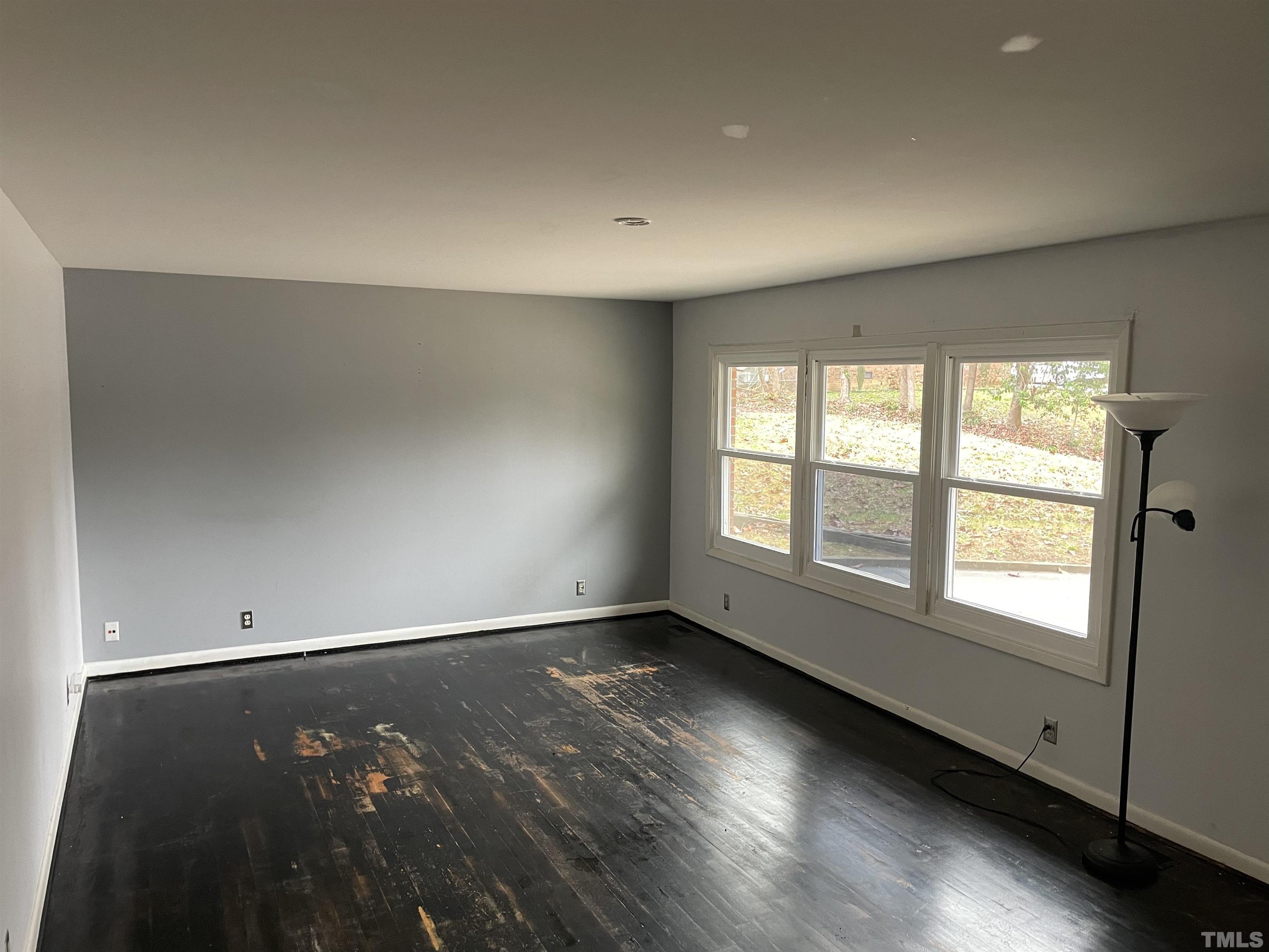 3300 Ashby Place Raleigh, NC 27604 - Photo 2 of 5 an empty room with wooden floor and windows