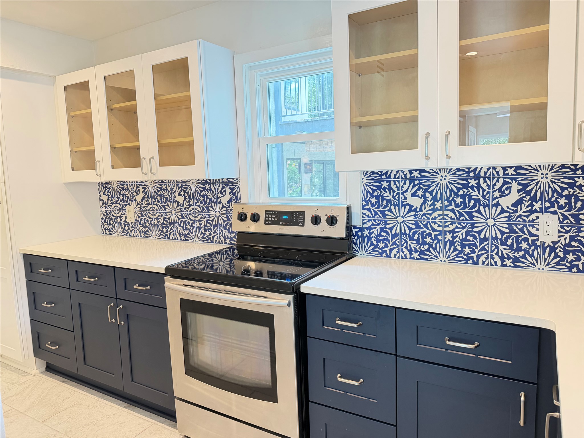 2918 Ranch Road 620 North, Unit C120 Austin, TX 78734 - Photo 10 of 34 A sleek kitchen with contemporary cabinetry and striking blue and white tile backsplash.
