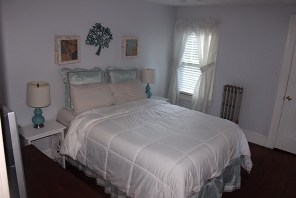 145 Springfield Street Springfield, MA 01107 - Photo 18 of 22 a bedroom with a bed a painting on the wall and a window