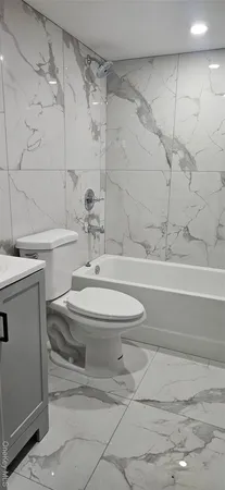 a bathroom with a toilet a sink and bathtub