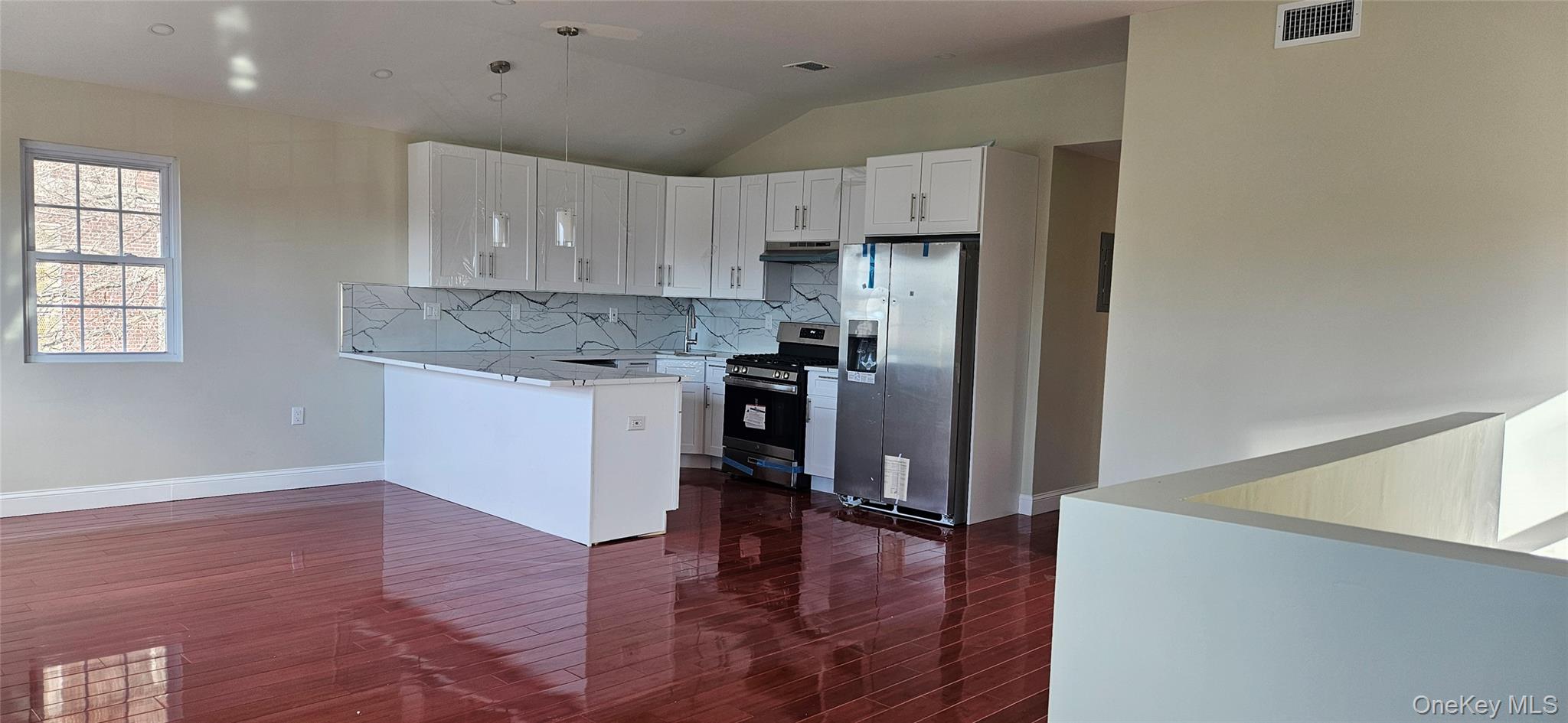 178-41 146th Terrace Queens, NY 11413 - Photo 18 of 23 a kitchen with kitchen island white cabinets and stainless steel appliances