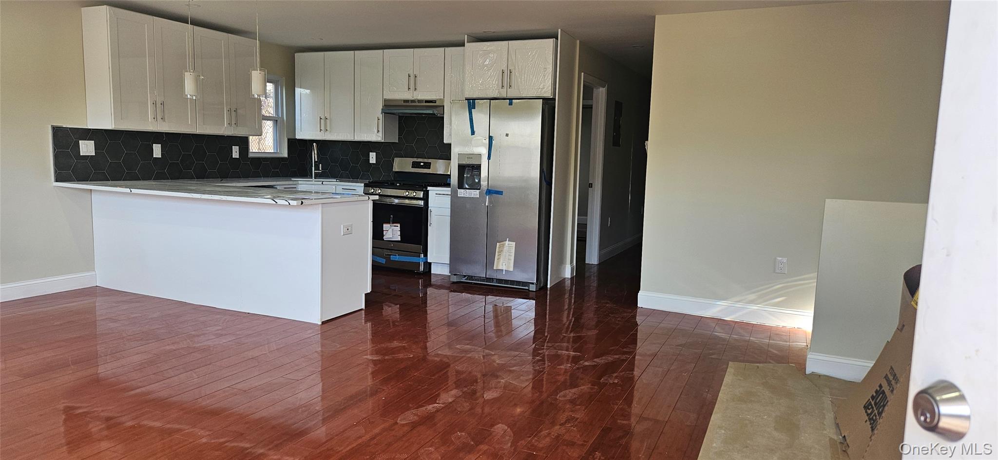 178-41 146th Terrace Queens, NY 11413 - Photo 2 of 23 a kitchen with granite countertop a refrigerator a sink and white cabinets