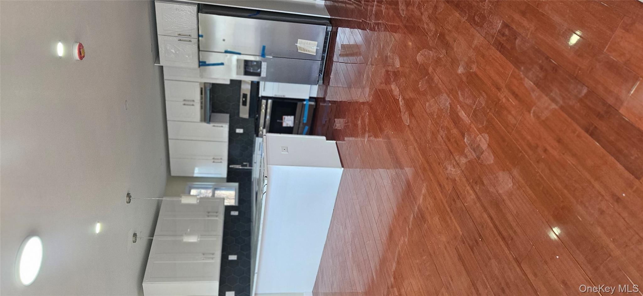 178-41 146th Terrace Queens, NY 11413 - Photo 3 of 23 a large kitchen with stainless steel appliances a large counter top a stove a sink and a refrigerator