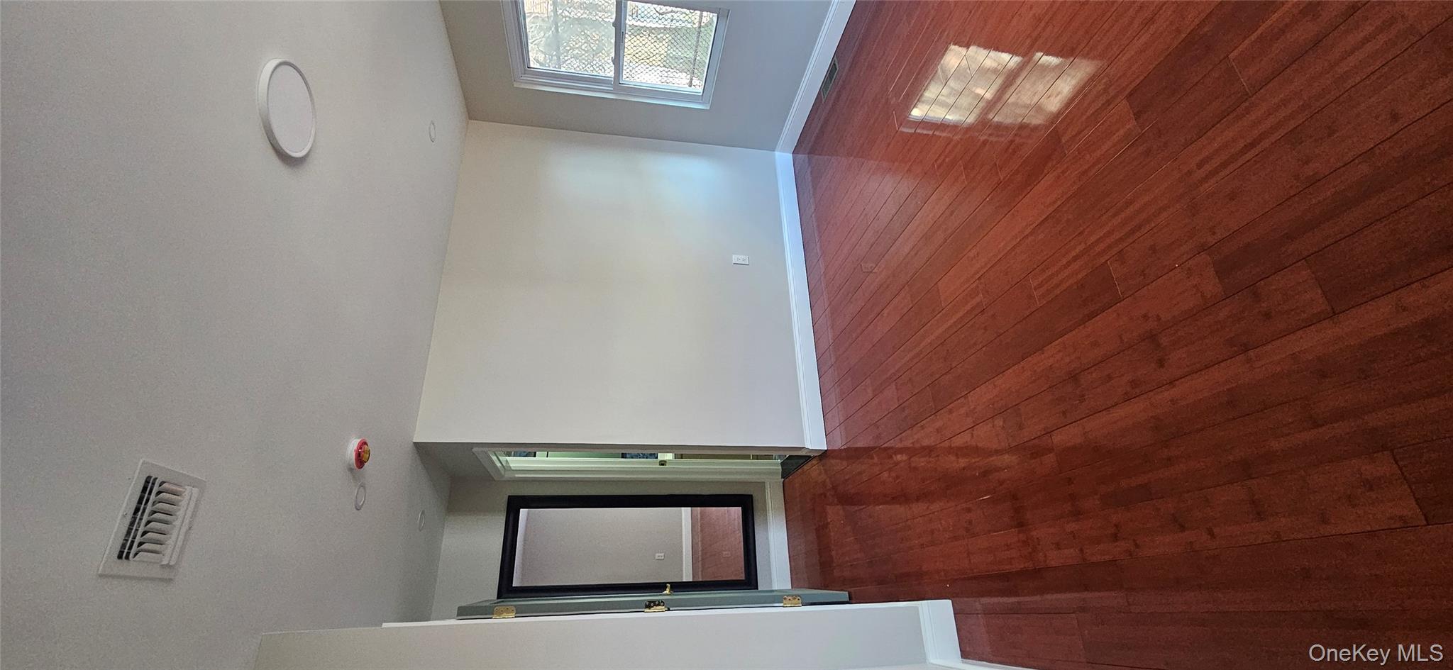 178-41 146th Terrace Queens, NY 11413 - Photo 9 of 23 an empty room with wooden floor and windows