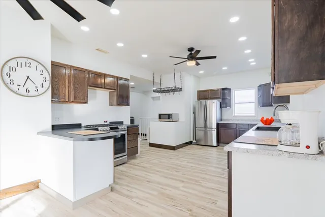 a kitchen with granite countertop a stove and a refrigerator