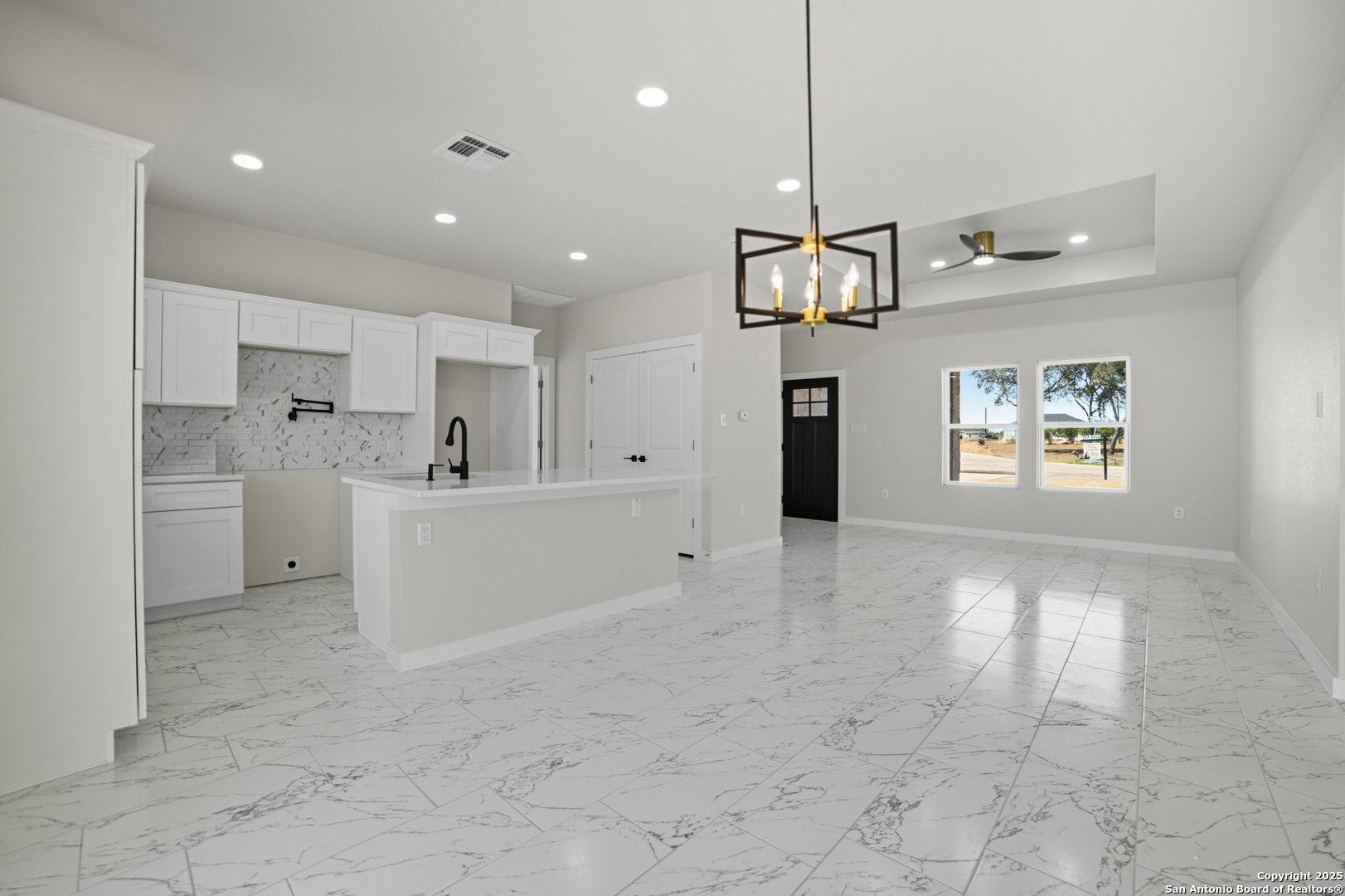 16724 Tapatio Street Atascosa, TX 78002 - Photo 11 of 29 a view of a kitchen with center island and stainless steel appliances