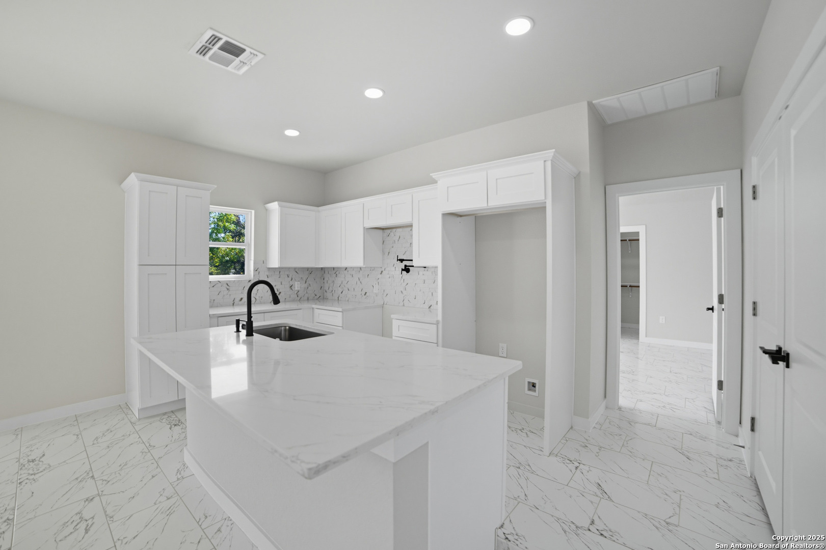 16724 Tapatio Street Atascosa, TX 78002 - Photo 13 of 29 a kitchen with a sink cabinets and refrigerator