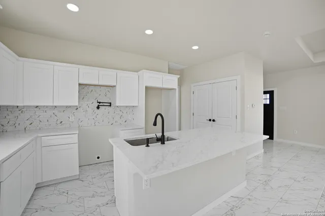 a kitchen with a sink and cabinets