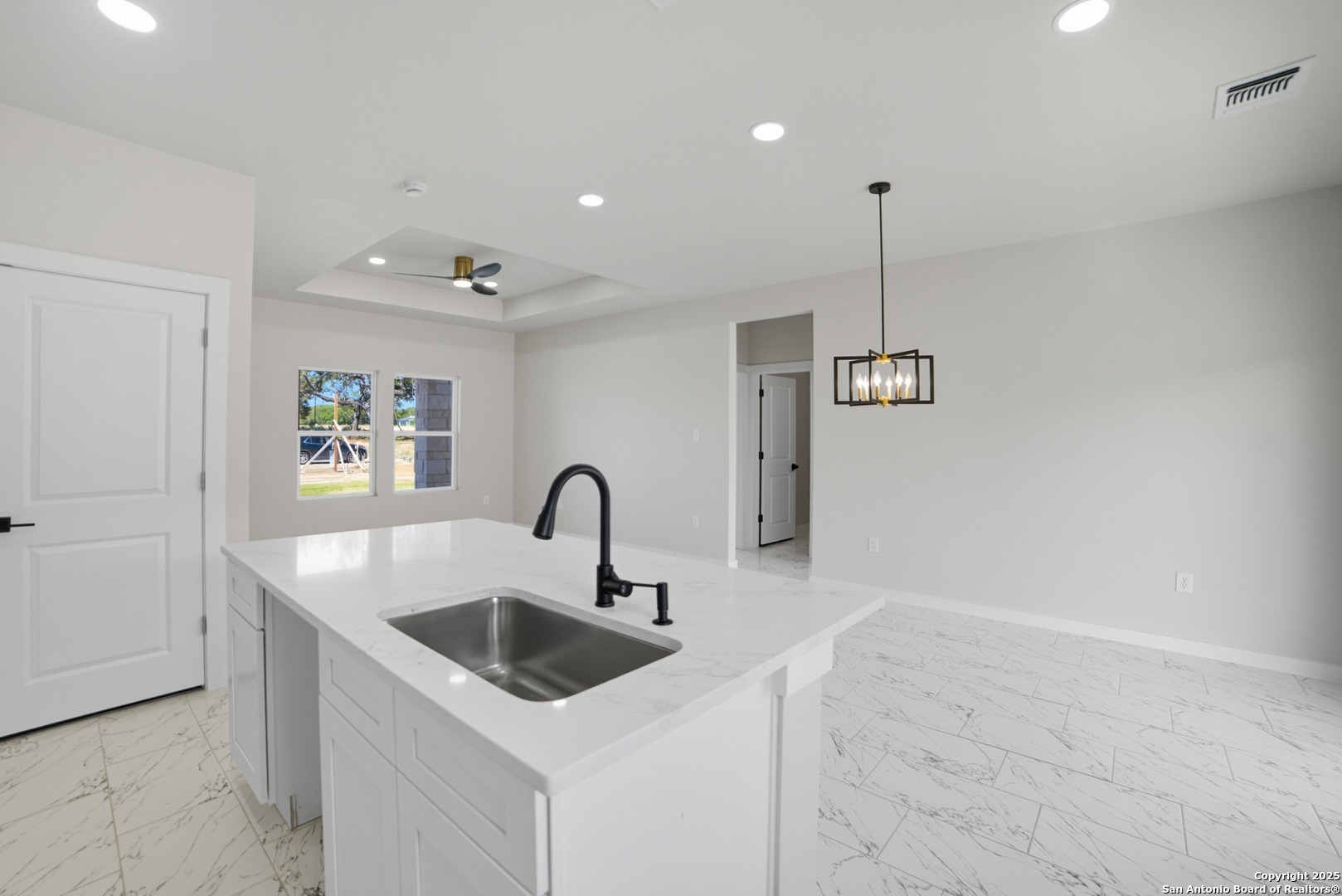 16724 Tapatio Street Atascosa, TX 78002 - Photo 16 of 29 a kitchen with a sink a counter space and cabinets