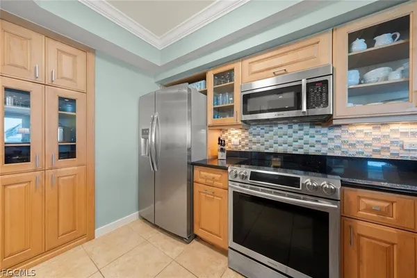 a view of a kitchen with a stove a sink and a refrigerator