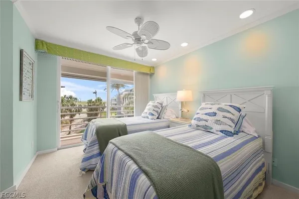 a bedroom with two beds and a chandelier