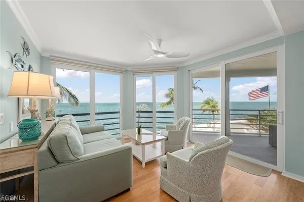a living room with furniture and large windows