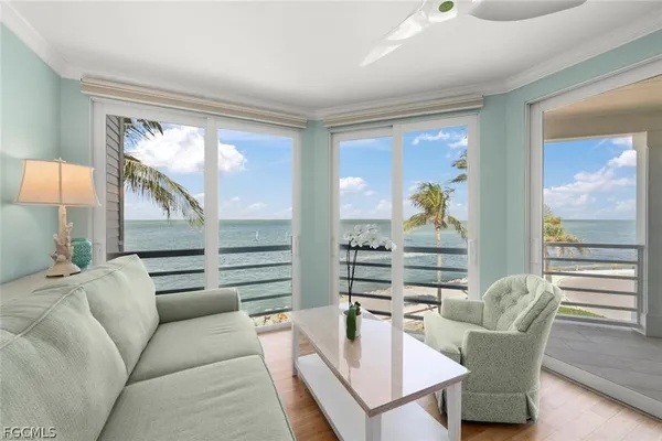 a living room with furniture and outdoor view