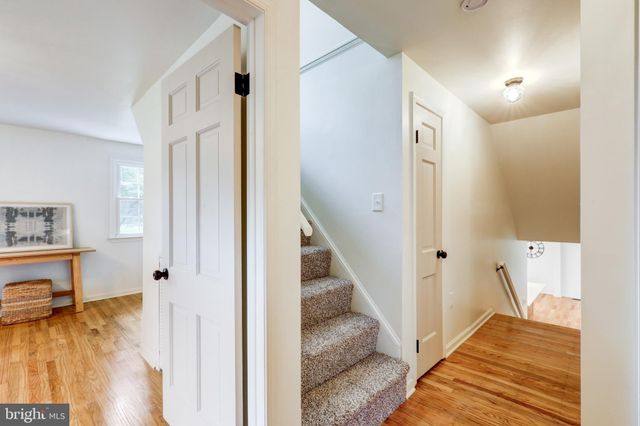 a view of a room with wooden floor and bathroom