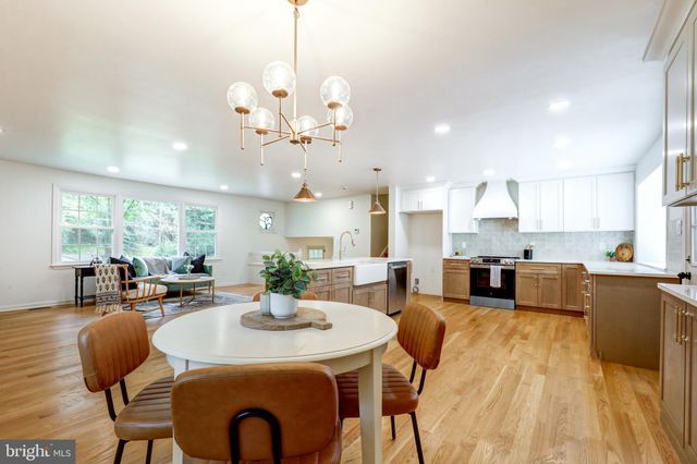 a large kitchen with stainless steel appliances kitchen island granite countertop a sink and cabinets