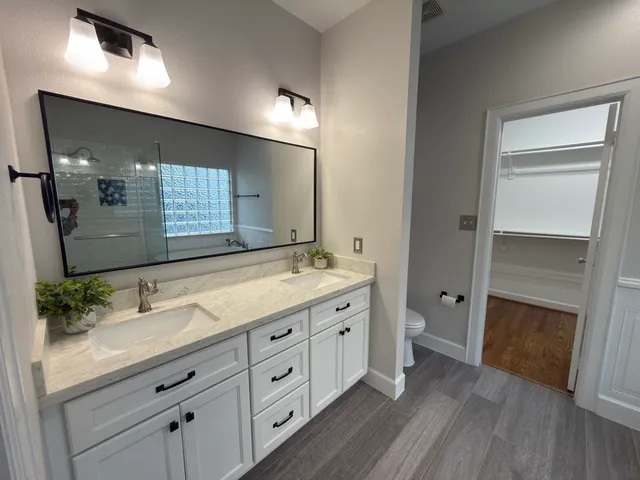 a bathroom with a double vanity sink and a mirror