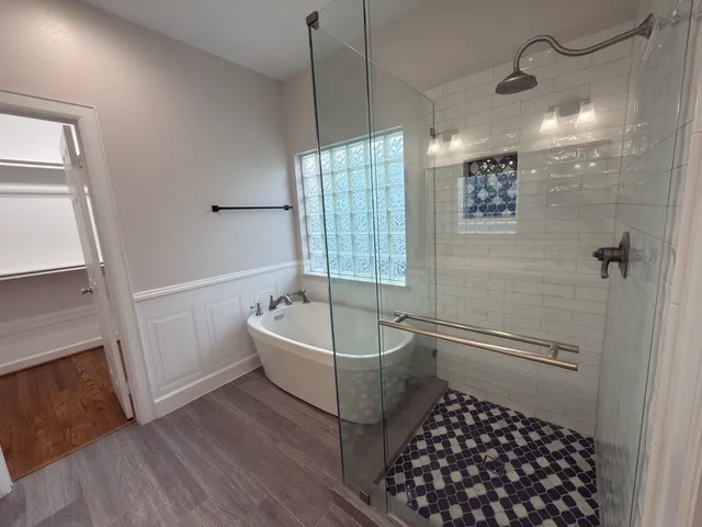 a bathroom with a bathtub a shower a toilet and a sink