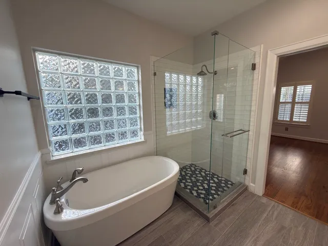 a bathroom with a bathtub and a shower