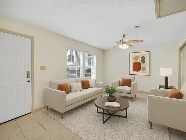 a living room with furniture and a large window