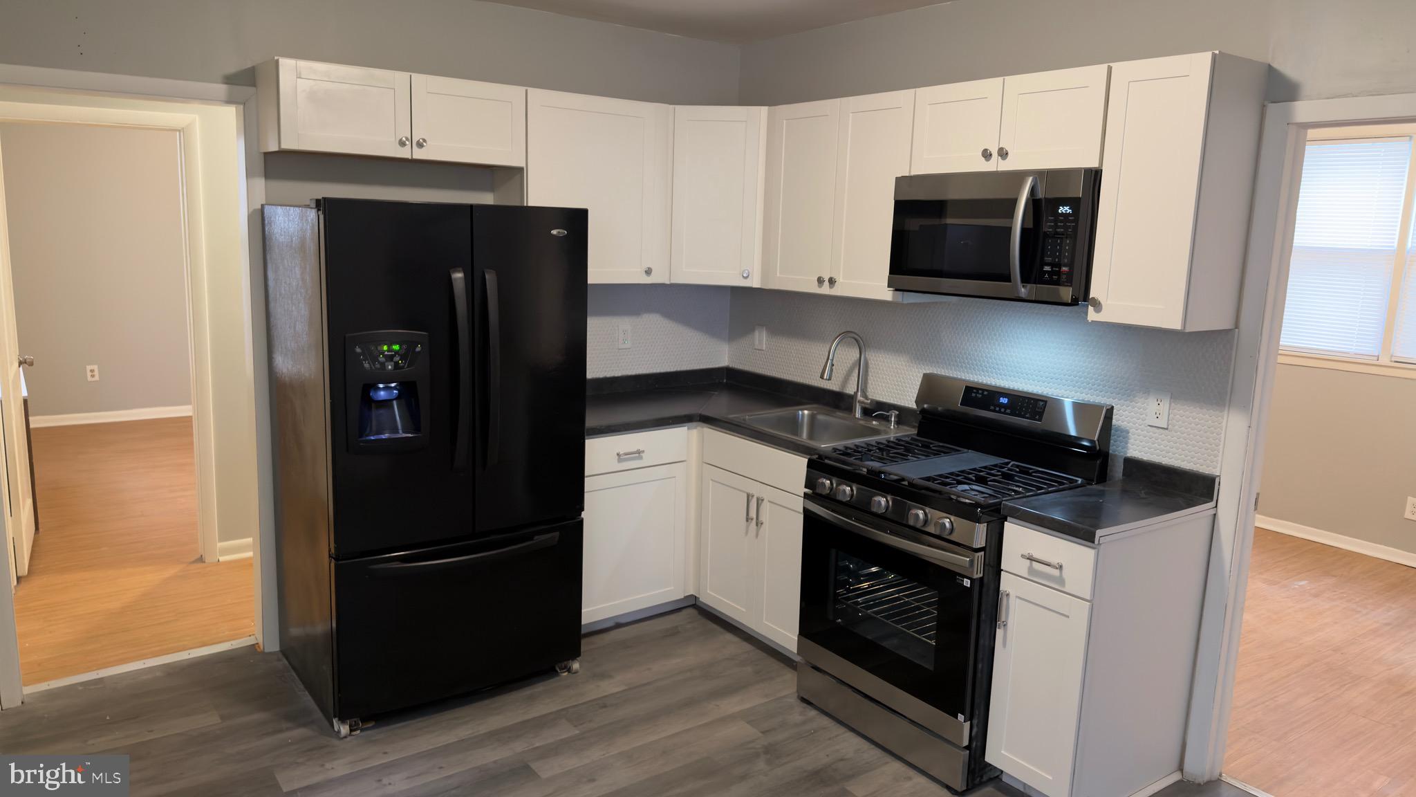 a kitchen with stainless steel appliances and wooden cabinets