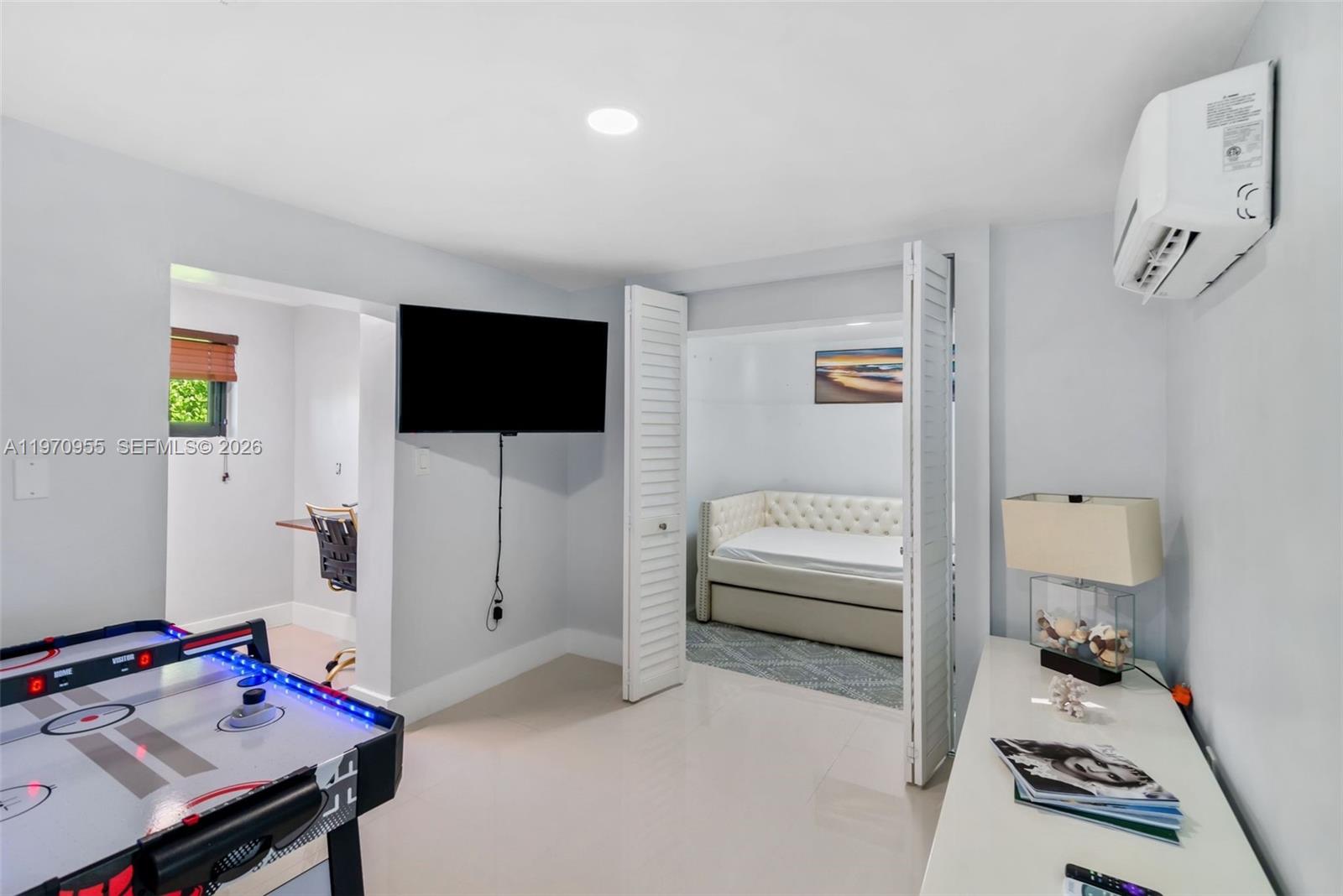 830 Southwest 93rd Avenue Miami, FL 33174 - Photo 27 of 48 a bedroom with furniture and a flat screen tv