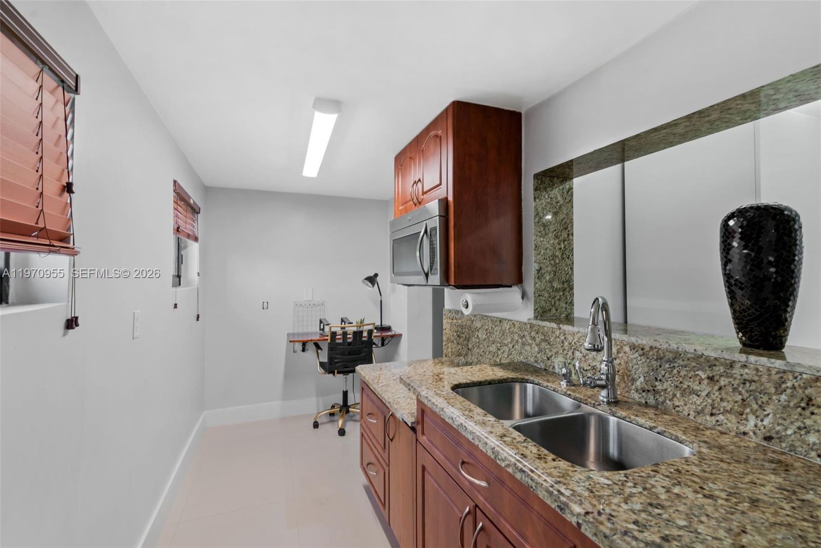 830 Southwest 93rd Avenue Miami, FL 33174 - Photo 30 of 48 a kitchen with stainless steel appliances a sink a stove and a refrigerator with wooden floor