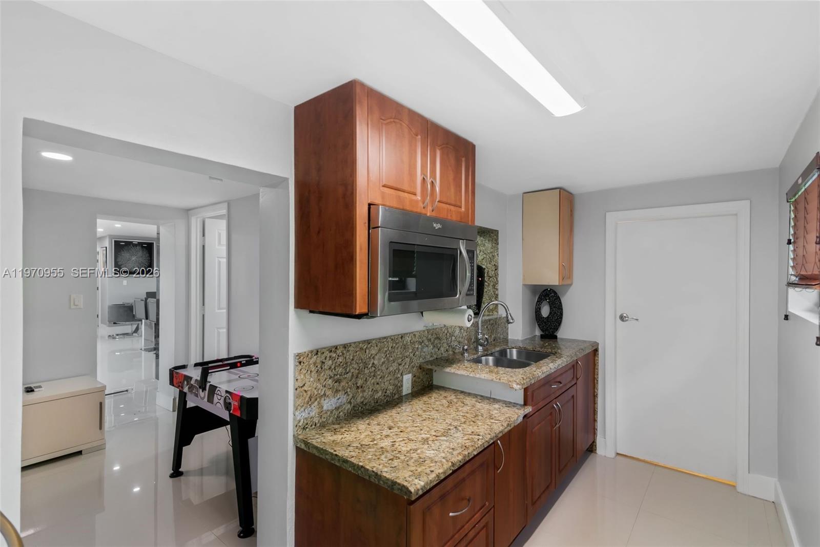 830 Southwest 93rd Avenue Miami, FL 33174 - Photo 32 of 48 a en suite bathroom with a granite countertop double vanity and a mirror