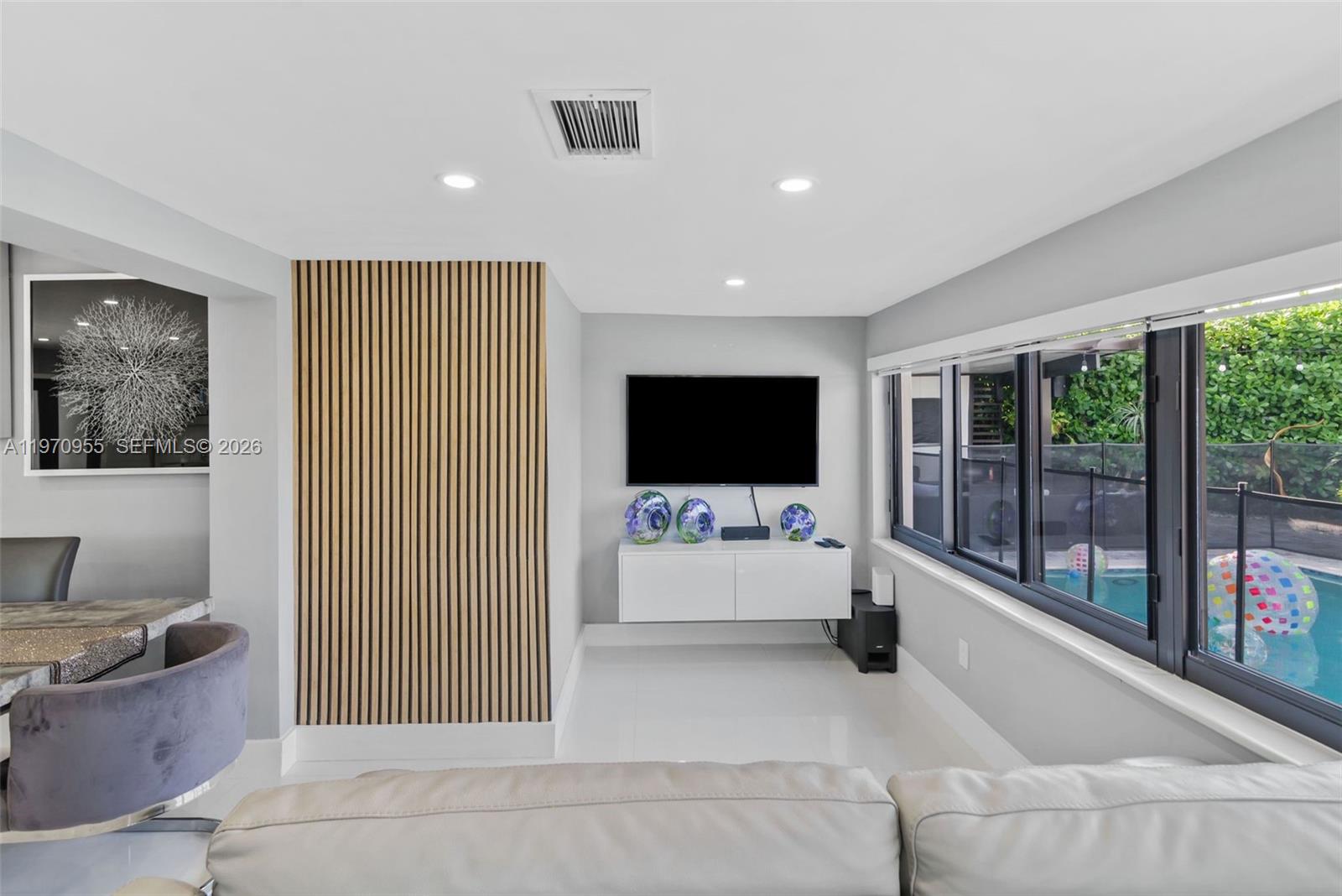 830 Southwest 93rd Avenue Miami, FL 33174 - Photo 35 of 48 a living room with furniture and a flat screen tv