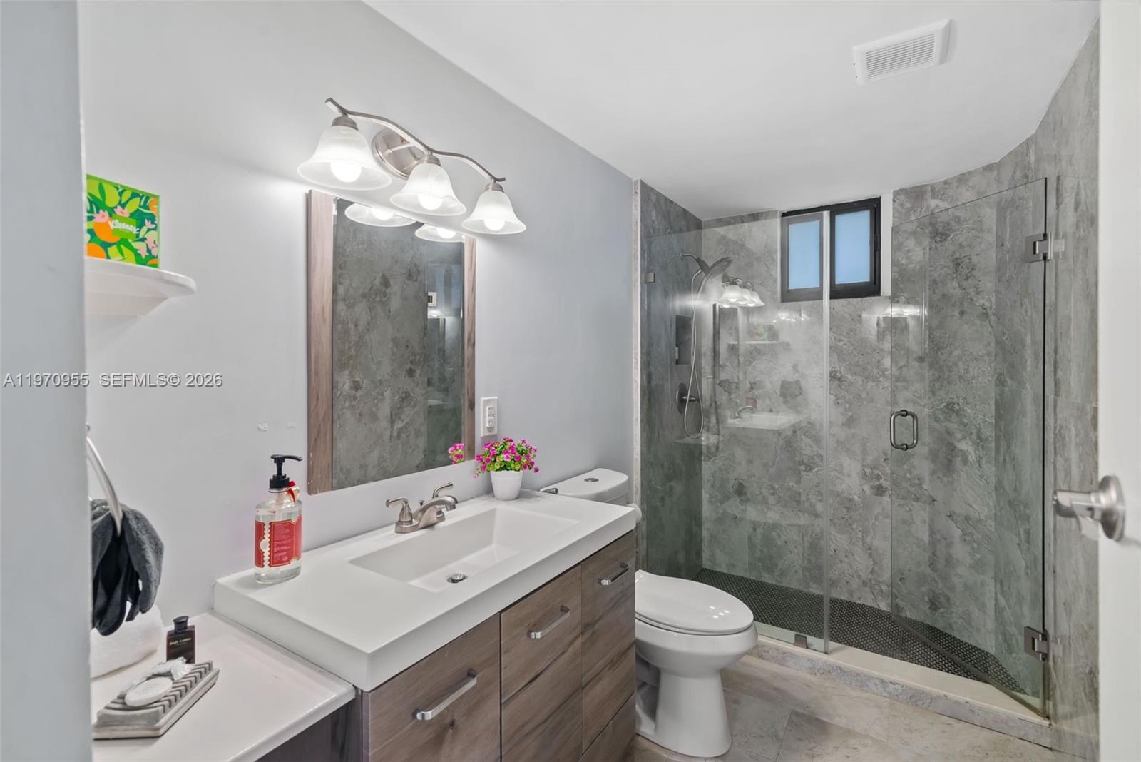 830 Southwest 93rd Avenue Miami, FL 33174 - Photo 36 of 48 a bathroom with a sink vanity mirror and toilet