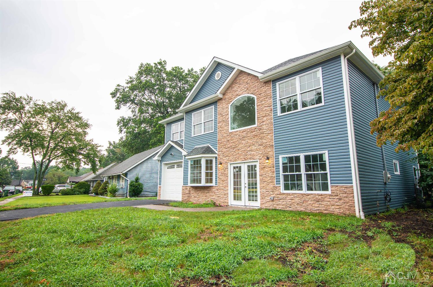 14 Caldwell Road Edison, NJ 08817 - Photo 2 of 22 a front view of a house with a yard and trees
