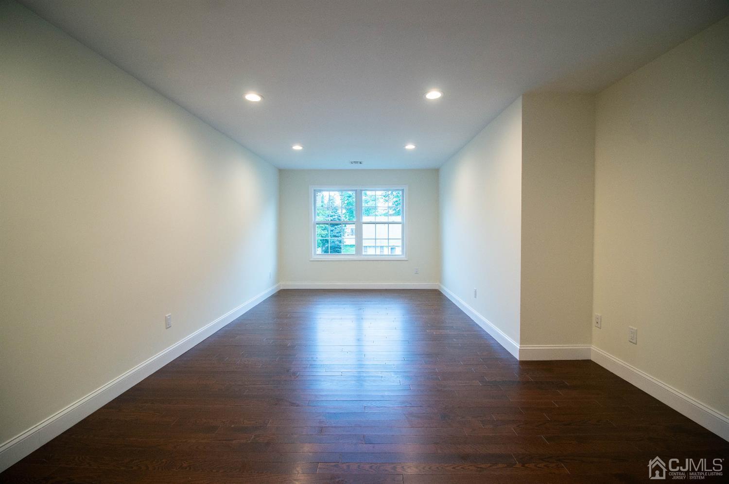 14 Caldwell Road Edison, NJ 08817 - Photo 11 of 22 an empty room with wooden floor and window